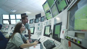 Scientists in accelerator control room --- Image by © Monty Rakusen/cultura/Corbis