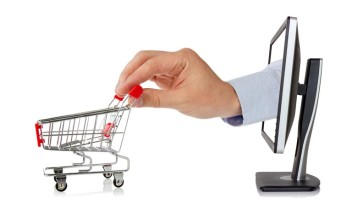 Computer monitor and hand with shopping cart