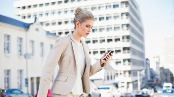 businesswoman-walking-with-smartphone-web